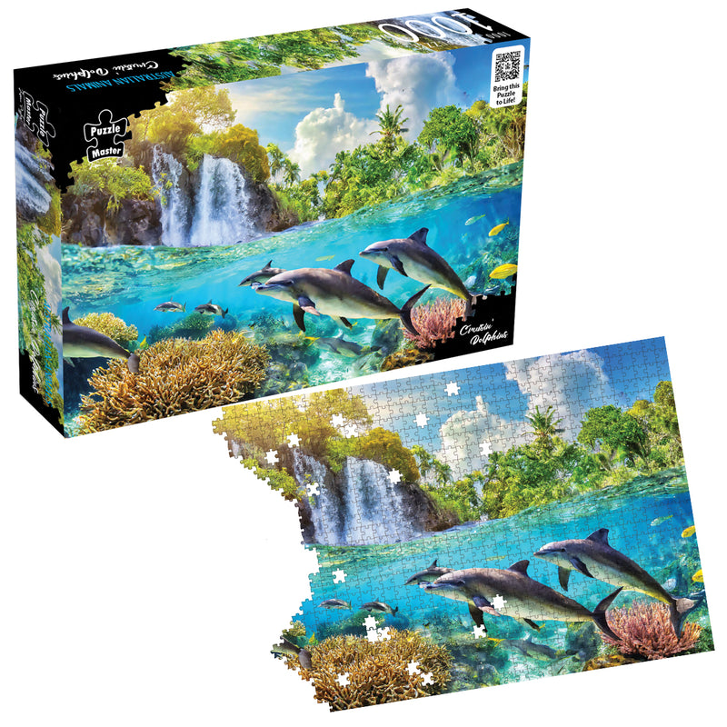 Load image into Gallery viewer, Puzzle Master Cruisin' Dolphins 1000-piece jigsaw puzzle box alongside a partially assembled puzzle showing dolphins beneath a tropical waterfall.
