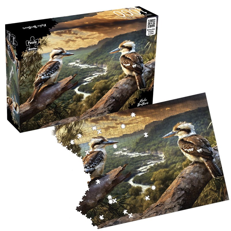 Load image into Gallery viewer, Puzzle Master Kooka Brothers jigsaw puzzle box shown above a partially assembled puzzle featuring two kookaburras on branches overlooking a valley.
